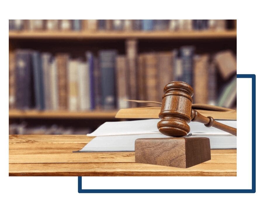 Gavel on table with books in background.